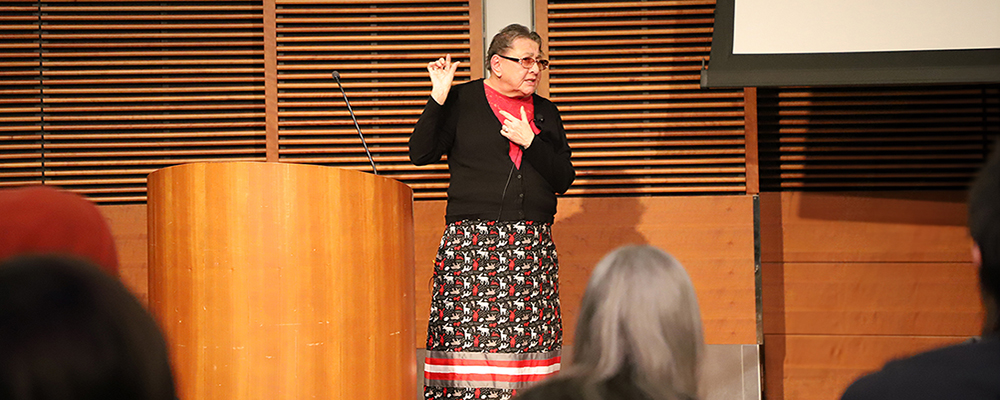 Val Barber Storytelling in-person at a podium