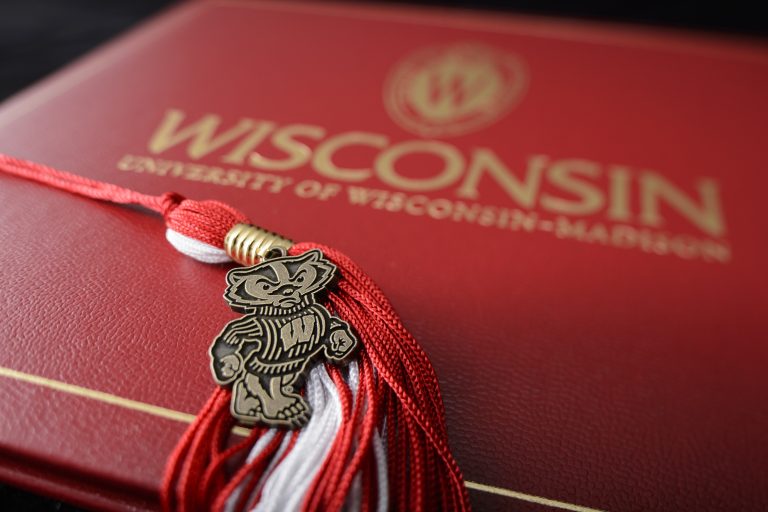 Close up image of a Wisconsin diploma cover and tassel